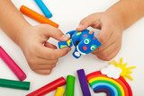 Child playing with colorful clay - closeup on hands  Fototapety do Przedszkola Fototapeta