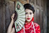 Chinese girl in traditional Chinese cheongsam blessing  Ludzie Obraz