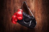 Sports bag and boxing gloves hanging on a wall  Sport Fototapeta