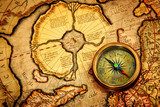 Vintage compass lies on an ancient map of the North Pole.  Mapa Świata Fototapeta
