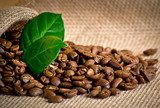 Coffee grains with bag and leaves on sackcloth  Kawa Fototapeta