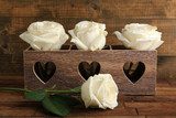 Beautiful white roses in decorative box on wooden table  Plakaty do Sypialni Plakat