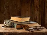 Vintage book, glasses and watches on the background of a wooden  Fototapety Sepia Fototapeta