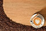 Top view of coffee cup and coffee beans on old wooden background  Fototapety do Kawiarni Fototapeta