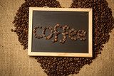 "coffee" spelled by coffee beans on black chalkboard against lin  Obrazy do Jadalni Obraz