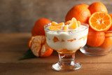 Tasty milk dessert with fresh tangerine pieces in glass bowl,  Obrazy do Jadalni Obraz