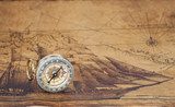 Vintage compass lies on an ancient map Styl Marynistyczny Fototapeta