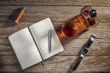 Overhead view of a notebook, whiskey, a knife, and a watch Plakaty do Biura Plakat