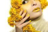 Yellow makeup and manicure with a sharp oval shape of the nails on the girl with the flowers. Obrazy do Salonu Kosmetycznego Obraz