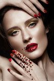 Beautiful girl with evening make-up, red lips in rhinestones and design manicure nails. beauty face. Photos shot in studio Obrazy do Salonu Kosmetycznego Obraz