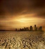 pollution theme with cracked land and the cityscape  Fototapety Sepia Fototapeta