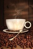 White coffee cup with spoon on roasted beans  Fototapety do Kawiarni Fototapeta