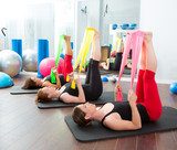 Aerobics pilates women with rubber bands in a row  Fototapety do Klubu Fitness Fototapeta