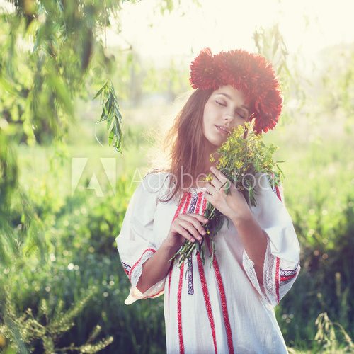 Emotional portrait of ukranian woman with bouquet of flowers  Folklor Fototapeta