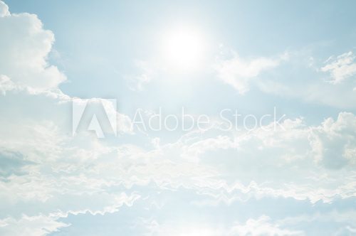 Blue sky with clouds and sun reflection in water.  Niebo Fototapeta