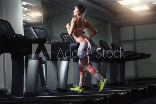 Young woman run on on a machine at the gym  Sport Plakat