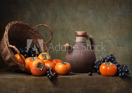 Still life with persimmons and grapes on the table  Obrazy do Kuchni  Obraz