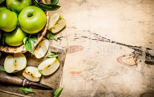 Fresh green apples in the basket with knife . Owoce Obraz
