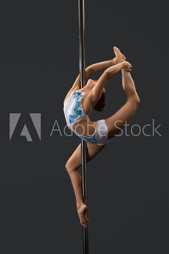 Modern dancer performing gymnastic split on pylon Fototapety do Szkoły Tańca Fototapeta