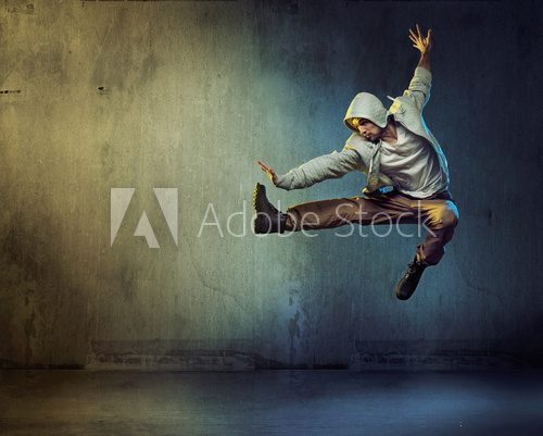 Athletic dancer in a jumping pose Fototapety do Szkoły Tańca Fototapeta