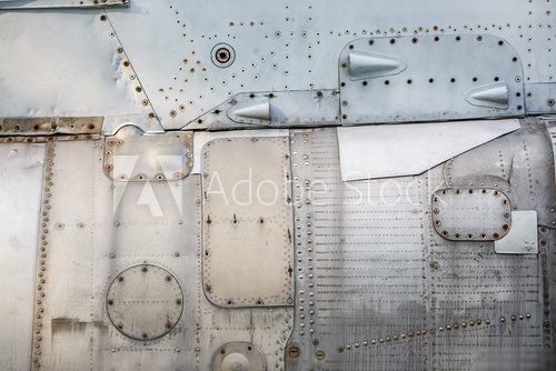 Abstract metal background. Old weathered silver metallic background. Vintage metal texture with rivets and bolts. Sheathing old plane. Old metal texture. Industrialne Fototapeta