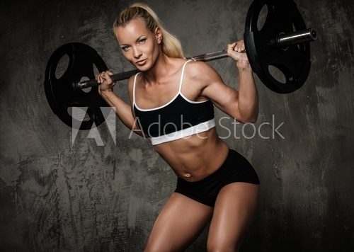 Beautiful muscular bodybuilder doing exercise with weights  Fototapety do Siłowni Fototapeta