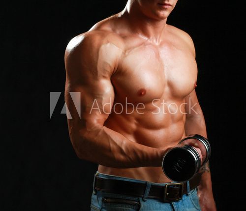 Handsome muscular man working out with dumbbells  Fototapety do Siłowni Fototapeta
