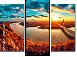 Beautiful panoramic aerial drone view to cable-stayed Siekierkowski Bridge over the Vistula river and Warsaw City skyscrapers, Poland in gold red autumn colors in November evening at sunset - Obraz trzyczęściowy, Tryptyk