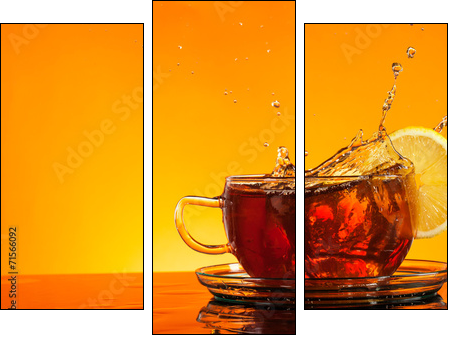 Tea splashing out of glass with orange background  - Obraz trzyczęściowy, Tryptyk