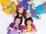 Happy school kids with colorful alphabet letters  Fototapety do Przedszkola Fototapeta