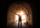 Man stands inside of old dark tunnel  Ludzie Obraz