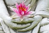 Buddha hands holding flower, close up  Orientalne Fototapeta