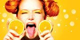 Beauty joyful teen girl with juicy oranges. Freckles  Ludzie Plakat