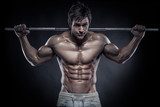 Muscular bodybuilder guy doing exercises with dumbbells over bla  Ludzie Plakat