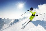 Skier in mountains, prepared piste and sunny day  Sport Fototapeta