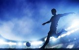 Football, soccer match. A player shooting on goal  Sport Fototapeta