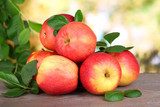 Ripe sweet apples with leaves on nature background  Plakaty do kuchni Plakat
