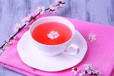 Fragrant tea with flowering branches on wooden table close-up  Plakaty do kuchni Plakat