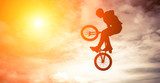 Man doing an jump with a bmx bike against sunshine sky.  Fototapety do Pokoju Nastolatka Fototapeta