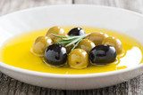 fresh olive oil and olives in a plate, close-up  Plakaty do kuchni Plakat