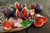 Tasty figs with ham on grey wooden table  Plakaty do kuchni Plakat