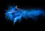 Young beautiful dancer jumping into blue powder cloud  Ludzie Obraz