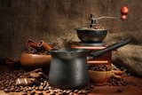 Coffee grinder, turk and cup of coffee on burlap background  Kawa Fototapeta