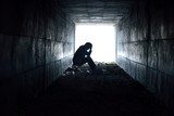 depressed man sitting in the tunnel  Ludzie Obraz