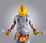 builder in a helmet with a hammer and a wrench  Ludzie Plakat