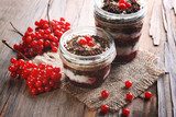Delicious dessert in jars on table close-up  Owoce Obraz