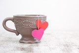 cup with heart shaped tea bag  Obrazy do Kuchni  Obraz