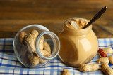 Fresh peanut butter in jar on wooden background  Obrazy do Kuchni  Obraz