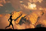 Silhouette of a woman running jogging in the mountains at sunset  Fototapety do Klubu Fitness Fototapeta