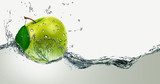Green Apple amid splashing water.  Owoce Obraz